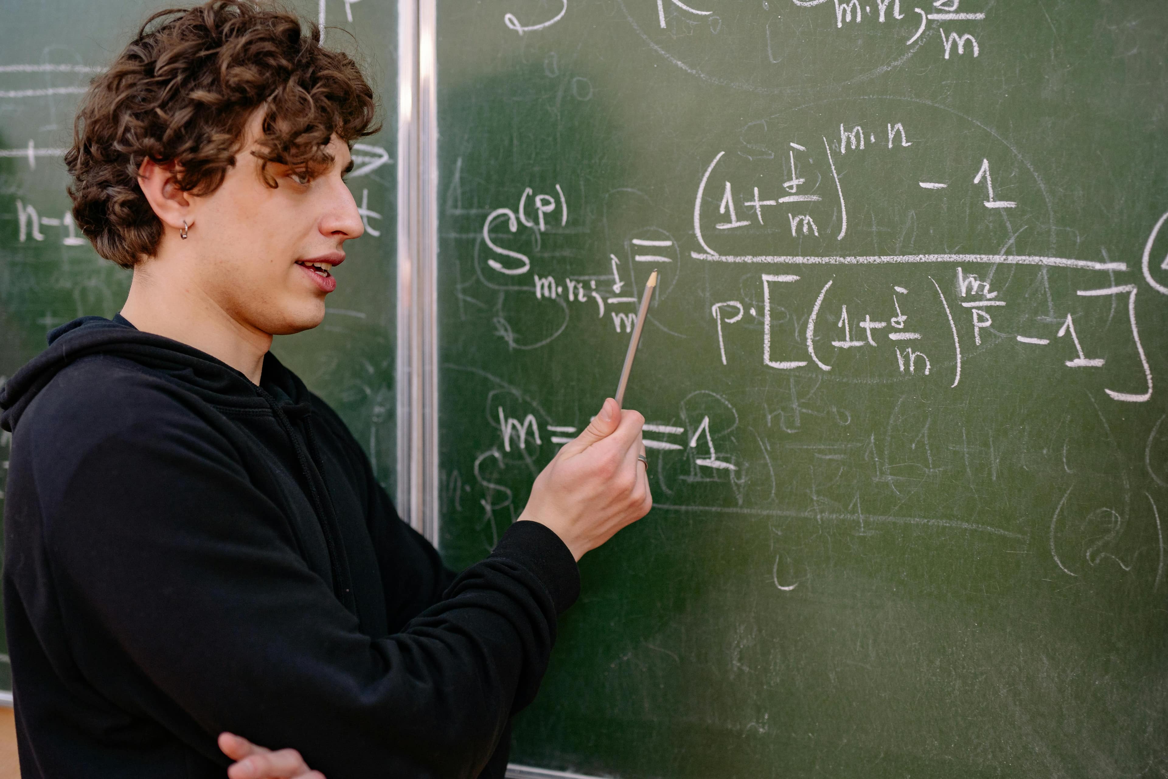 A Logosphere tutor explaining at a chalkboard